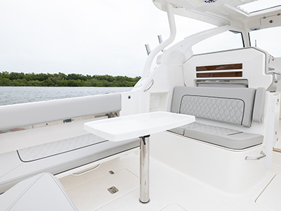 Pursuit DC 365 luxury dual console boat cockpit seating with stoable table.