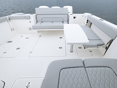 Pursuit DC 365 luxury dual console boat cockpit seating with stoable table.