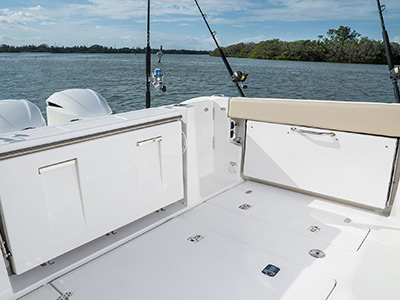 Pursuit DC 365 dual console boat cockpit social zone with seats folded up.