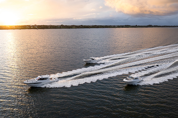 Pursuit Boats fleet of Flagship boats cut through the water at sunset.