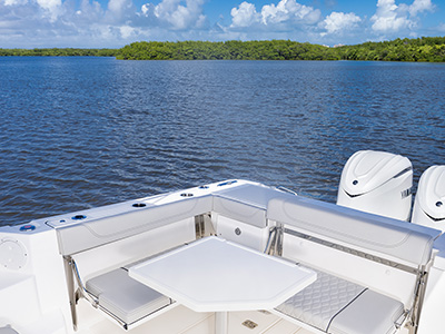 Detail view of OS 355 offshore boat bridge deck social zone with Table perfect for entertaining.