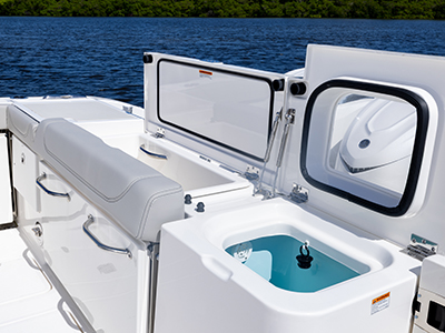 Transom with fishbox and livewell open on Pursuit OS 405 Offshore cabin cruiser fishing boat.