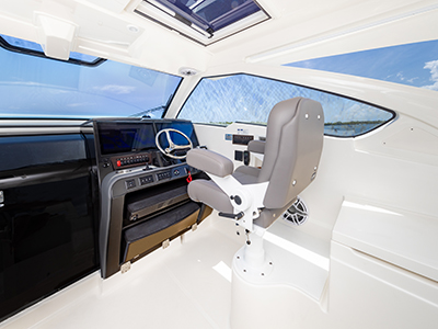 The helm with Stidd seat on the Pursuit OS 405 Offshore cabin cruiser fishing boat.