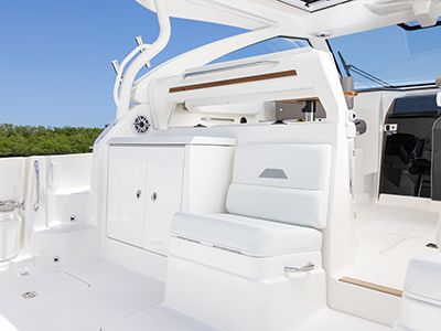 Aft facing seat and storage areas in the cockpit of a Pursuit 40 ft offshore boat.