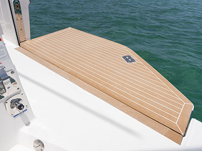 Teak-finished swim platform and transom door on a Pursuit OS 445.