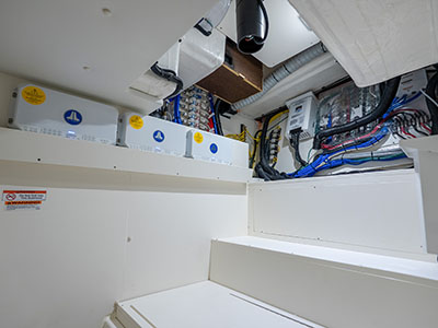 Electrical distribution panel and systems compartment aboard a Pursuit OS 445.