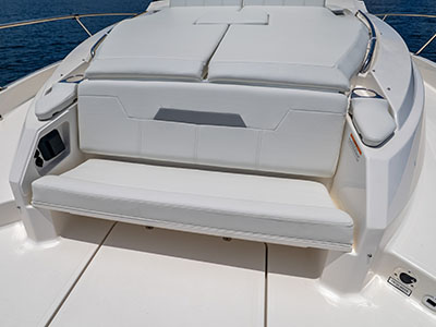 Bow seating and sunpad of a Pursuit OS 445 with storage beneath.