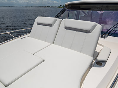 Bow sunpad of a Pursuit OS 445 laid flat with twin headrests.