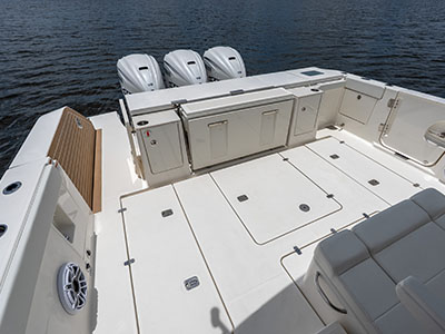 Cockpit of a Pursuit OS 445 from above, showing teak decking, deck hatches, and transom seating.
