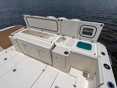 Open transom station on a Pursuit OS 445 with sink, livewell, and tackle storage.