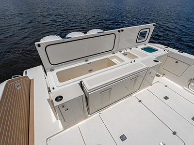 Transom prep station of a Pursuit OS 445 with the livewell and storage hatches open.