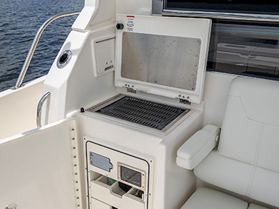 Cockpit galley module with grill and seating aboard a Pursuit OS 445.