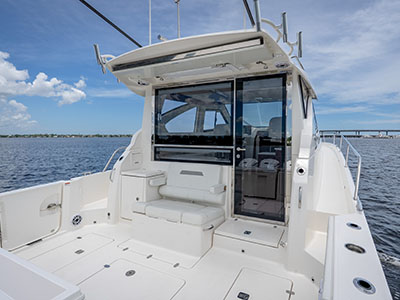 Cockpit of a Pursuit OS 445 looking forward to the salon door beneath the hardtop.