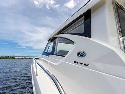 OS 445 hull-side badge on a Pursuit OS 445 with open water behind.
