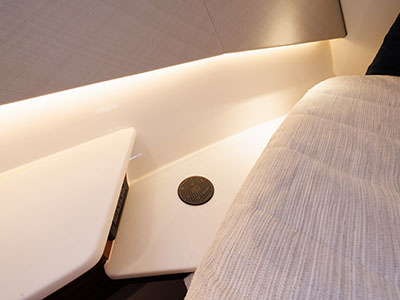 Cabin detail aboard a Pursuit OS 445 showing berth corner and concealed LED lighting.