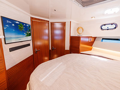 Berth and mounted television in the cabin of a Pursuit OS 445.