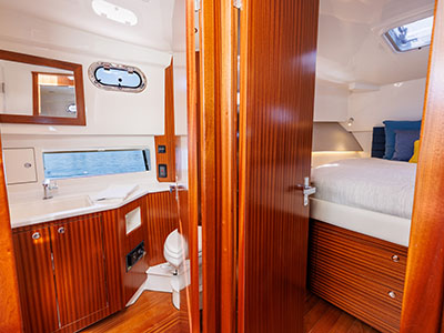 View through the cabin door of a Pursuit OS 445 toward the berth and head.