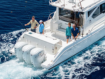 Aerial view of four anglers fishing from the cockpit of a Pursuit OS 445 while underway.