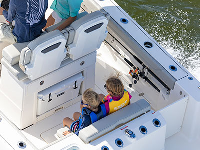 Kids use transom seat on Pursuit S 248 Center Console Sport Boat.