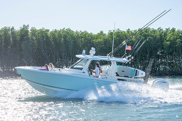 Woman at the helm running a Pursuit S 328 Sport.