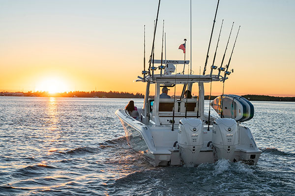 Pursuit S 328 Sport Center Console boat at sunset.