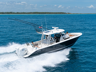 A side view of Pursuit Boats S 358 Sport Center Console Boat running right in saltwater with twin Yamaha engines.