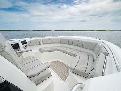 The bow of a Pursuit Boat S 358 Sport Center Console boat with lounge seating.