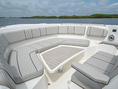 Bow view with table as foot rest for sunpad on Pursuit Boat’s S 358 Sport Center Console boat.