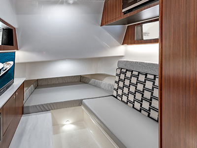 Interior photo of the Pursuit S 358 Sport Center Console boat’s cabin with a V berth.