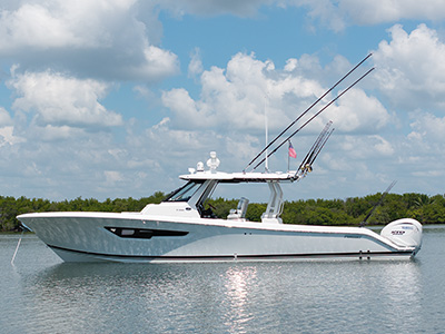 Profile view of A Pursuit S 388 Sport boat facing left.
