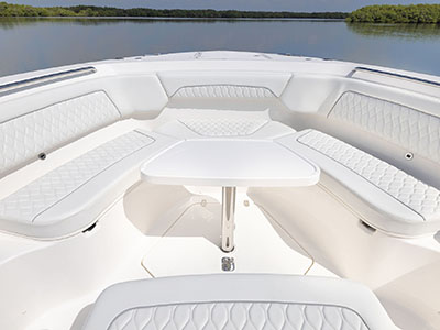 Bow seating with table installed for entreating on a Pursuit S 388 center console boat.