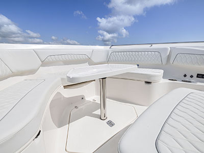 Bow seating with table installed for entreating on a Pursuit S 388 center console boat.