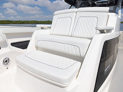 Forward lounge seating on Pursuit Center Console S 388 boat.