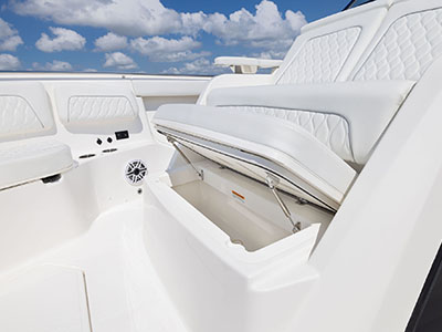 Storage in lounge seating in bow of Pursuit S 388.