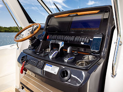 Helm of the Pursuit S 388 Center Console boat with teak finishes.
