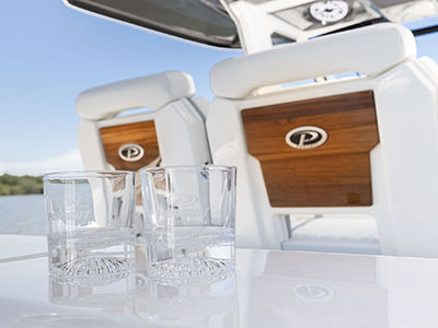 Glasses rest on the entertainment center behind the helm of the Pursuit S 388.