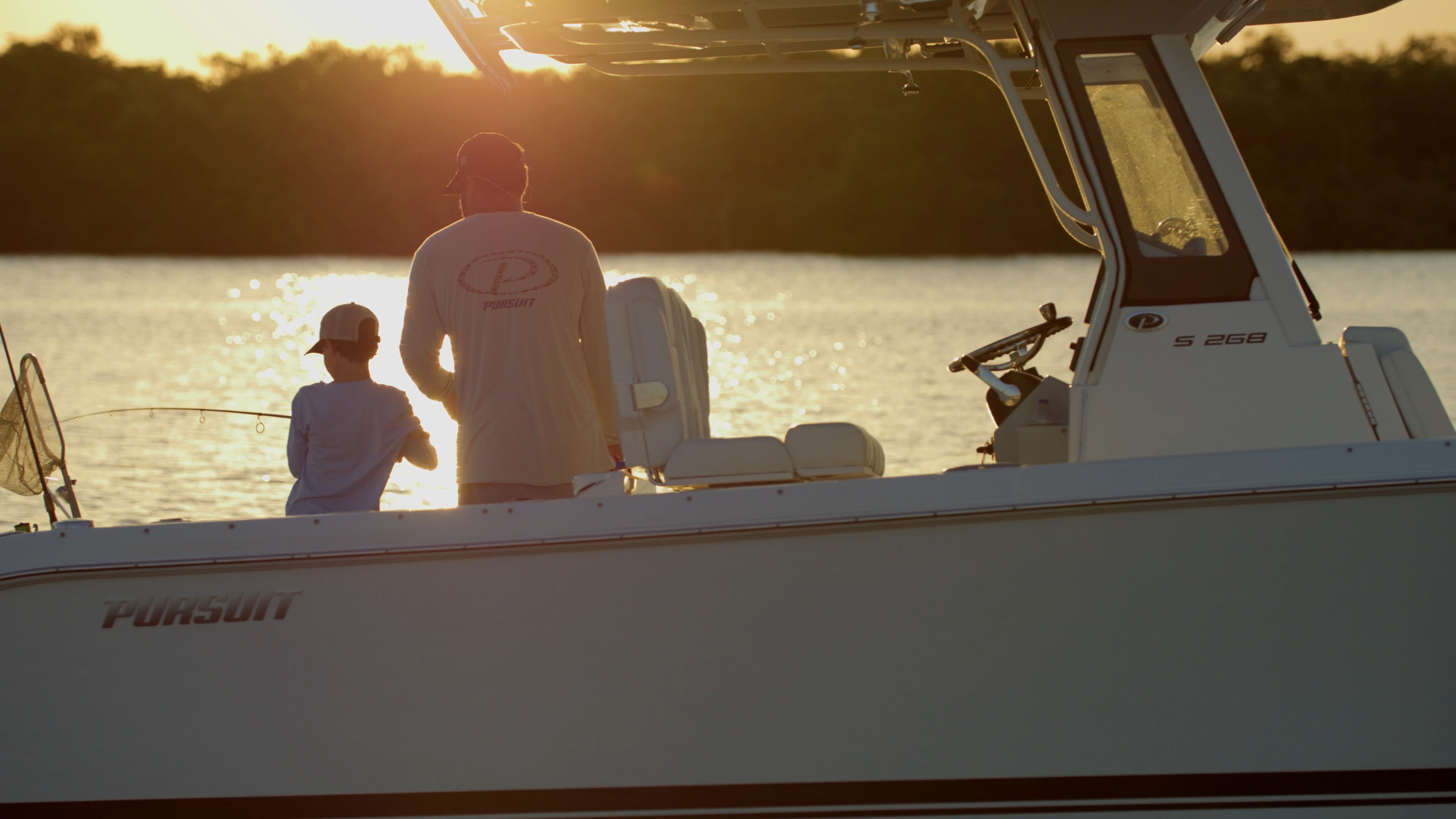 Father and son fishing at sun rise.