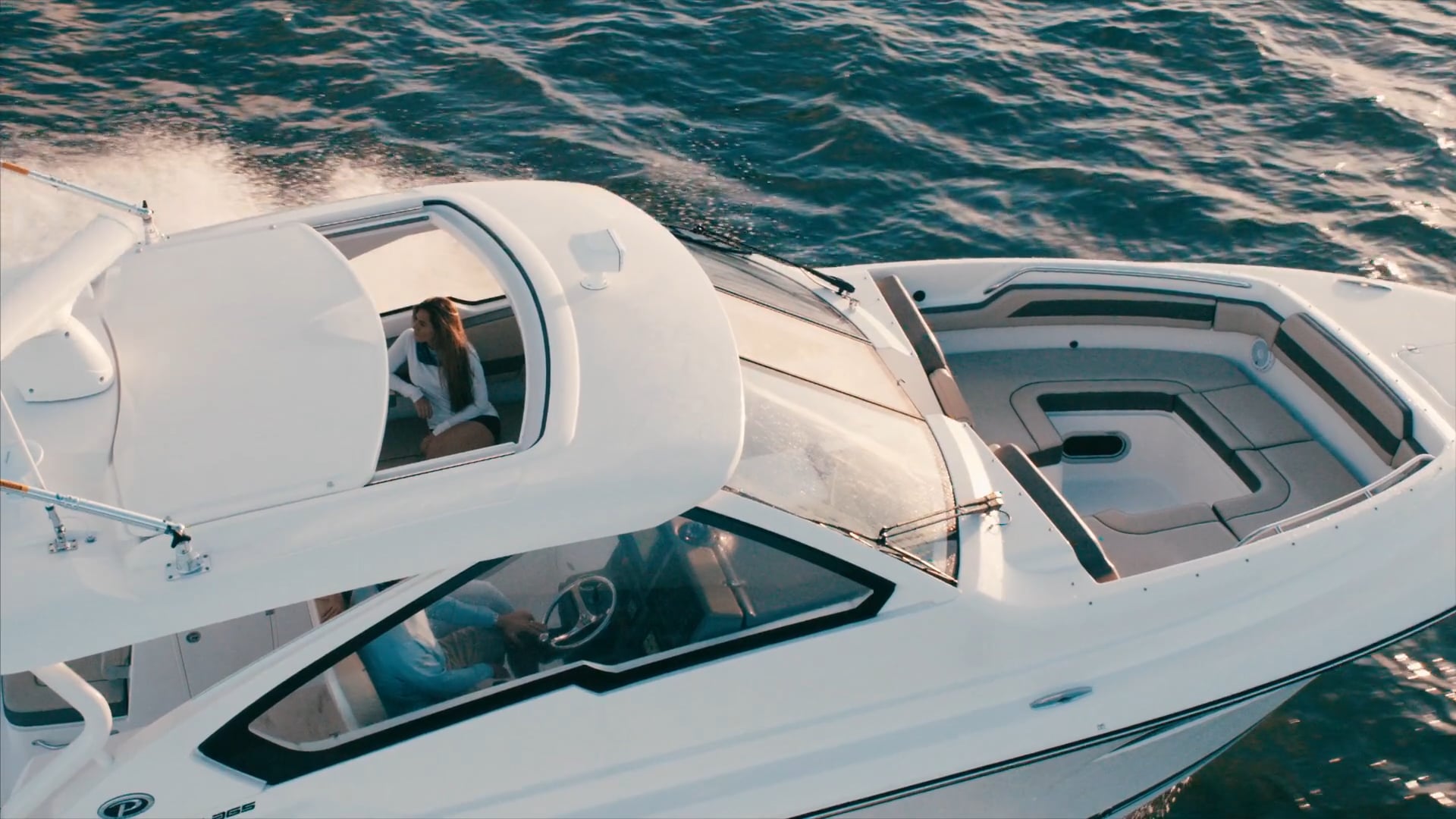 Aerial profile view of white Pursuit DC 365 dual console boat.