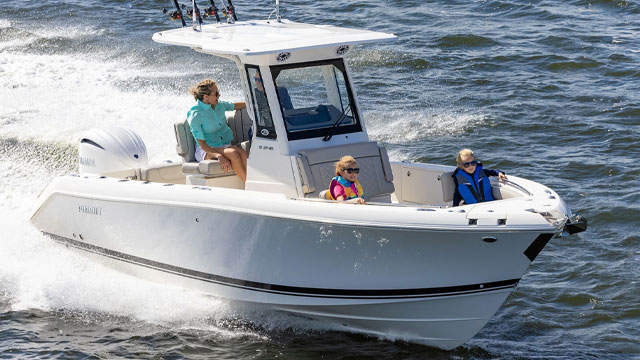 Mother and son fishing off the side of a Pursuit S 248 Center Console Sport Boat