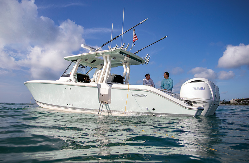 Pursuit Boats S 328 Sport boat anchored offshore.