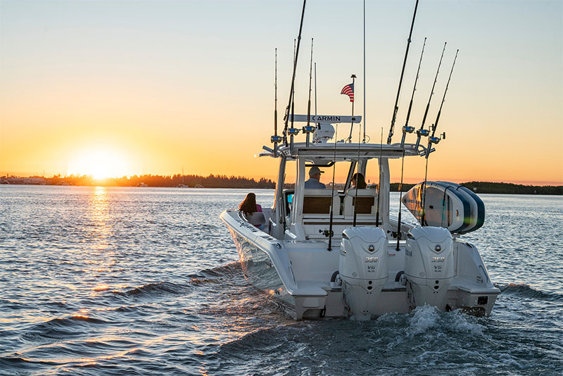 Pursuit S 328 Sport Center Console boat at sunset.