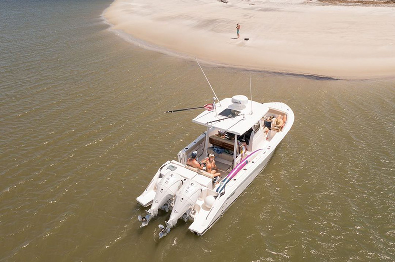 A Pursuit Boat pulls up to Tybee Island at low tide.