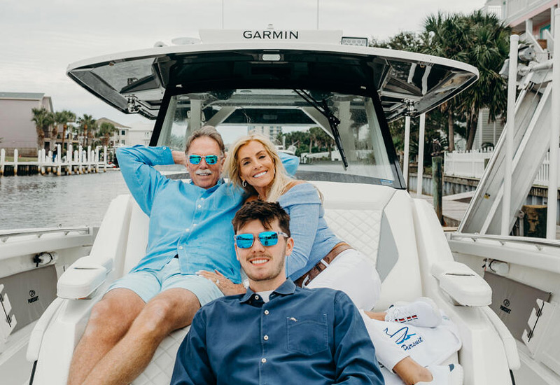 Happy family aboard their Pursuit S 428
