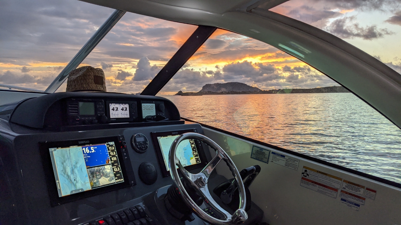 Sunrise through helm side window on a Pursuit Offshore boat