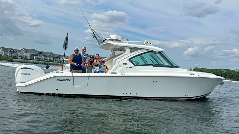 A happy family aboard their Pursuit DC 326 in Long Island.