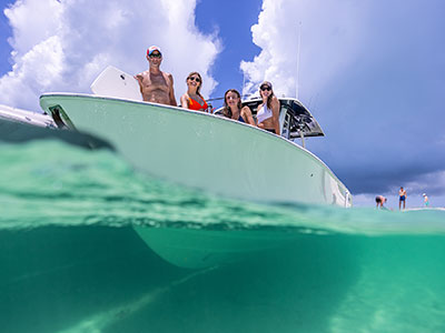 Over/under photo of a family on a Pursuit in the Bahamas.