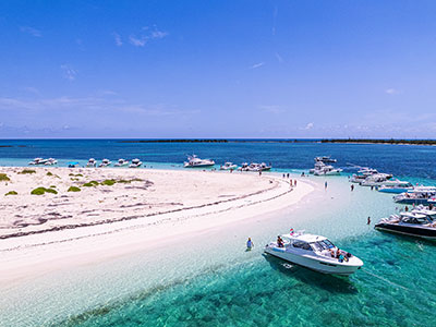 Pursuit Boats nestled together in the blue waters of the Bahamas.