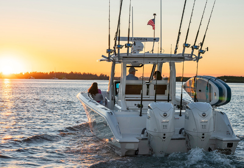 Pursuit S 328 Sport Center Console boat at sunset.
