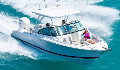 A girl enjoys riding on a bowrider D 246 Pursuit dual console boat with hardtop.