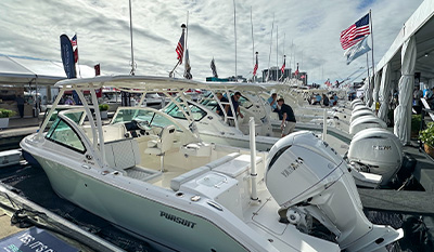 Pursuit models in water at boat show.